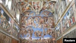 Pope Francis poses in the Sistine Chapel with members of the diplomatic corps accredited to the Holy See at the end of an audience for the traditional exchange of New Year greetings at the Vatican, Jan. 9, 2017.