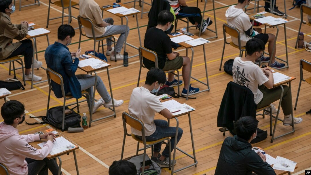 FILE - Students sit for the Diploma of Secondary Education (DSE) exams April 26, 2021, in Hong Kong.
