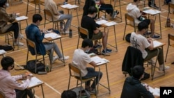 FILE - Students sit for the Diploma of Secondary Education (DSE) exams April 26, 2021, in Hong Kong.