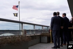 FBI Director Kash Patel and Adam Boehler, U.S. presidential envoy for hostage affairs, watch as the Hostage and Wrongful Detainee flag is raised at the State Department on March 6, 2025, in Washington.