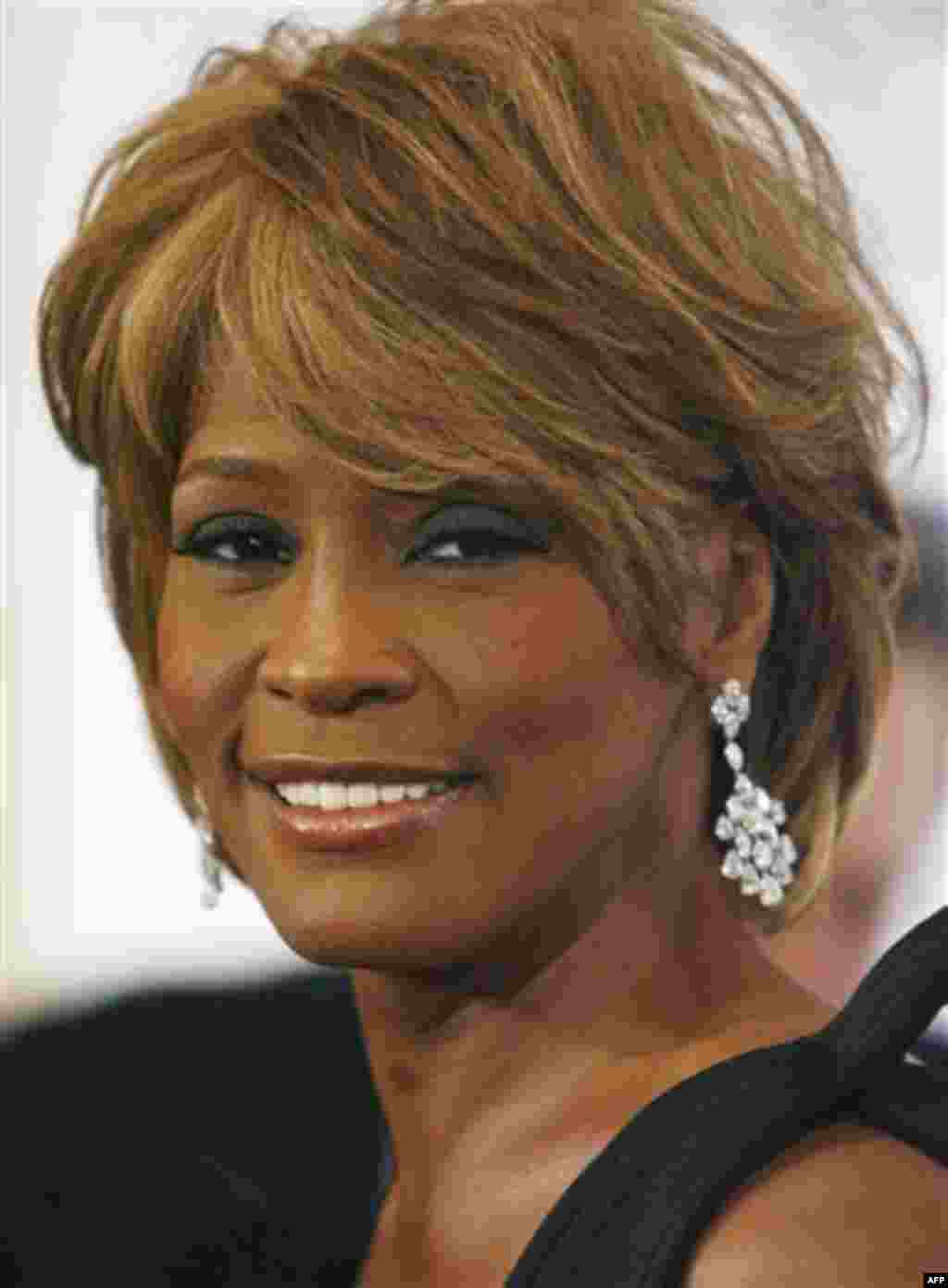 **FILE** Musician Whitney Houston arrives at the 17th Carousel of Hope Ball benefiting the Barbara Davis Center for Childhood Diabetes in Beverly Hills, Calif., Oct. 28, 2006. Houston's divorce from singer Bobby Brown will become final on April 24 and Hou