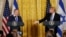 FILE - U.S. President Donald Trump, right, reaches out to Israeli Prime Minister Benjamin Netanyahu during a joint news conference at the White House in Washington, Feb. 15, 2017. 