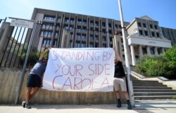 Demonstrators hold a banner in support of Carola Rackete, the 31-year-old Sea-Watch 3 captain, outside the court in Agrigento, Sicily, Italy, July 1, 2019.