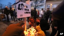 People attend a commemoration in Kosice, Slovakia, Feb. 21, 2020, to mark the second anniversary of the slayings of an investigative reporter and his fiancee. Jan Kuciak and Martina Kusnirova were shot dead in their home. 
