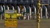 FILE - Warning signs are posted in front of a gas compressor station, a part of the Polish section of the Yamal pipeline that links Russia with western Europe and is owned in part by Gazprom, in Gabinek near Wloclawek, Poland, May 23, 2022. 