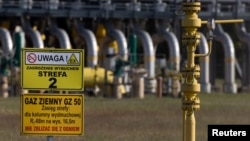 FILE - Warning signs are posted in front of a gas compressor station, a part of the Polish section of the Yamal pipeline that links Russia with western Europe and is owned in part by Gazprom, in Gabinek near Wloclawek, Poland, May 23, 2022. 