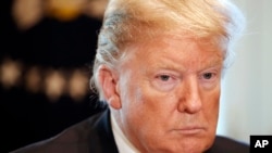 President Donald Trump attends a roundtable discussion on border security with local leaders, Friday Jan. 11, 2019, in the Cabinet Room of the White House in Washington. 