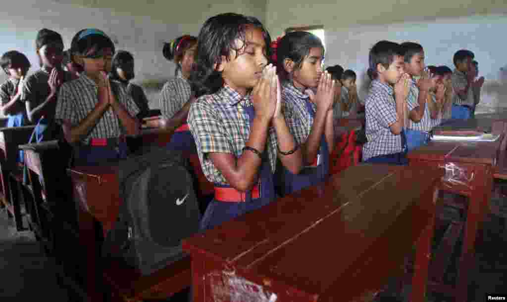 Schoolchildren pray inside their classroom for the victims of Kolkata&#39;s collapsed flyover bridge, in Agartala, India. The bridge, which was under construction, killed at least 23 people and injured 80 more on Thursday.