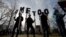 Demonstrators spell out "#MeToo" during a local Women's March in Cambridge, Mass., Jan. 20, 2018. 
