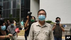 Pro-democracy activist Cheung Man-kwong walks out of a court after receiving a suspended sentence in Hong Kong, Wednesday, Sept. 15, 2021. Nine Hong Kong activists and ex-lawmakers were handed jail sentences of up to 10 months, and three others…