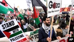 FILE - Pro-Palestinian demonstrators march during a visit by President Joe Biden in Warren, Mich., Feb. 1, 2024.