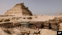 FILE - Building materials gather dust at the foot of the Djoser Pyramid in Saqqara, Egypt, September 16, 2014.