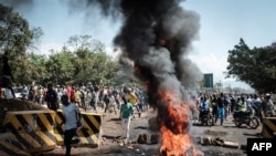 Opposition supporters block streets and burn tires during a protest in Kisumu, Kenya, on Oct. 11, 2017. Supporters of Kenya's opposition leader Raila Odinga took to the streets as poll officials mull their next move after his withdrawal from an upcoming presidential election.