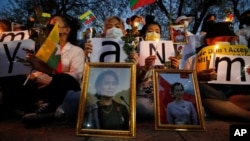 Myanmar nationals living in Thailand attend a candle light vigil as they protest against the military coup in front of the United Nations building in Bangkok, Thailand, Thursday, March 4, 2021. (AP Photo/Sakchai Lalit)