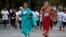 Middle-aged women in traditional Indian attire run along with youngsters during a 5-kilometer run, organized to celebrate International Women's Day in Bangalore, India, March 8, 2015.