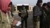 Rebel fighters stand with their weapons on the outskirts of the northern Syrian town of al-Bab, Syria, Feb. 8, 2017. 