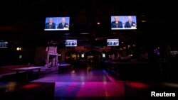 Television screens broadcast the second 2020 presidential campaign debate between Democratic presidential nominee Joe Biden and U.S. President Donald Trump at The Abbey Bar during the outbreak of the coronavirus disease (COVID-19), in West Hollywood,…