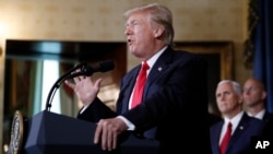 President Donald Trump speaks, accompanied by Vice President Mike Pence, second from right, during an event about healthcare in the Blue Room of the White House, July 24, 2017, in Washington.