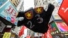 FILE - A sign in the shape of a hand with the colors of the Chinese national flag for fingernails and a "23" on its palm with reference to the controversial Article 23 law is carried by protesters at a rally in Hong Kong, Oct. 1, 2018.