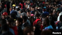 Unemployed people line up to fill out applications while looking for job opportunities in downtown Sao Paulo, Brazil, Aug. 6, 2018.