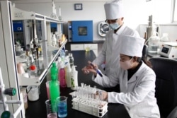 Workers of the Ryongaksan Soap Factory make disinfectants in Pyongyang, North Korea, March 19, 2020.