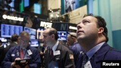 Traders work on the floor of the New York Stock Exchange, October 23, 2012. 