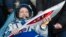 Russian cosmonaut Fyodor Yurchikhin holds the torch of the 2014 Sochi Winter Olympic Games after landing near the town of Zhezkazgan in central Kazakhstan Nov. 11, 2013.
