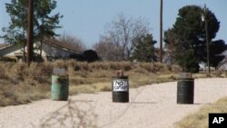 The driveway to the Shatto family home, rear left, is seen in Gardendale, Texas, March 1, 2013.