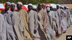 Men who were being detained on suspicion of affiliation to Boko Haram, line up as they are released by the Nigerian military in Maiduguri, Nigeria, July 6, 2015