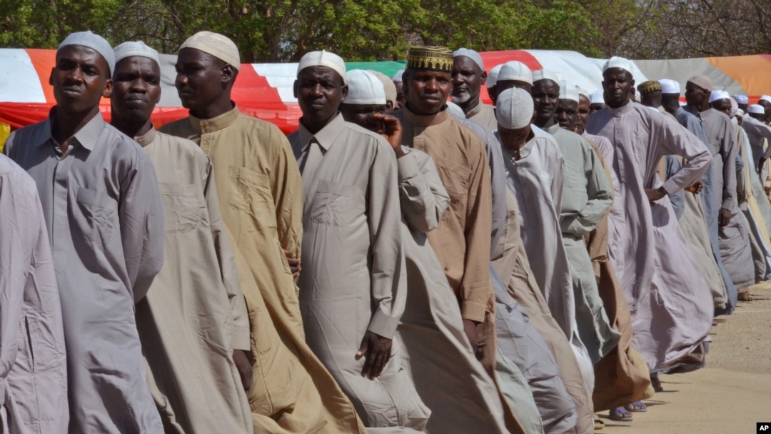 FILE - Men line up in July 2015 after being detained on suspicion of affiliation with Boko Haram.
