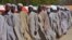 FILE - Men line up in July 2015 after being detained on suspicion of affiliation with Boko Haram.