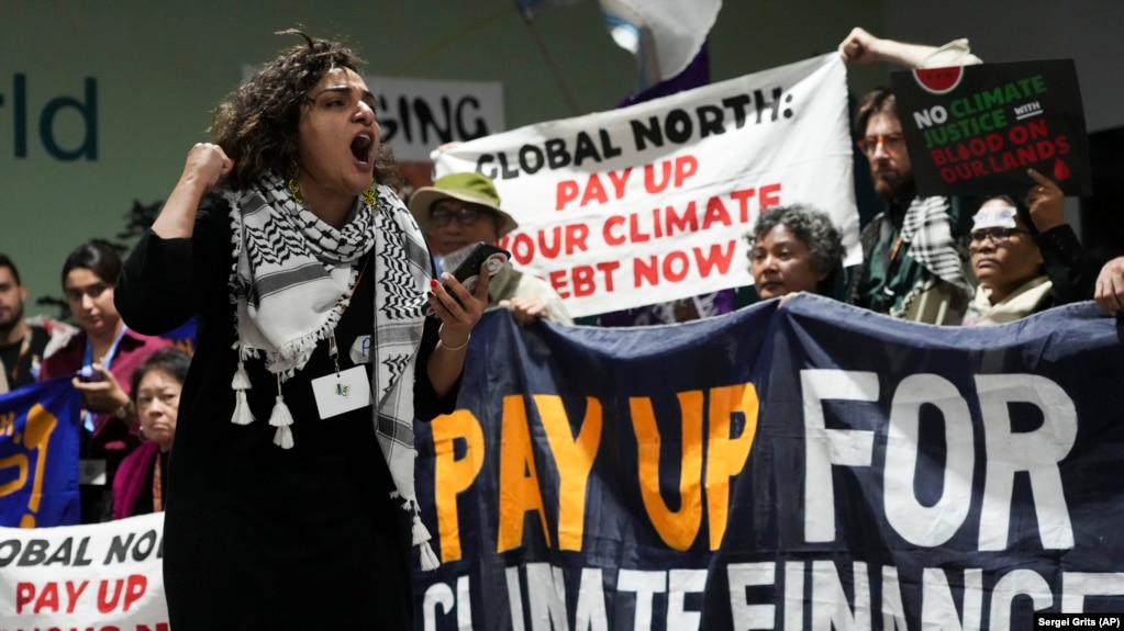 Activists participate in a demonstration for climate finance at the COP29 U.N. Climate Summit, Friday, Nov. 22, 2024, in Baku, Azerbaijan. (AP Photo/Sergei Grits)