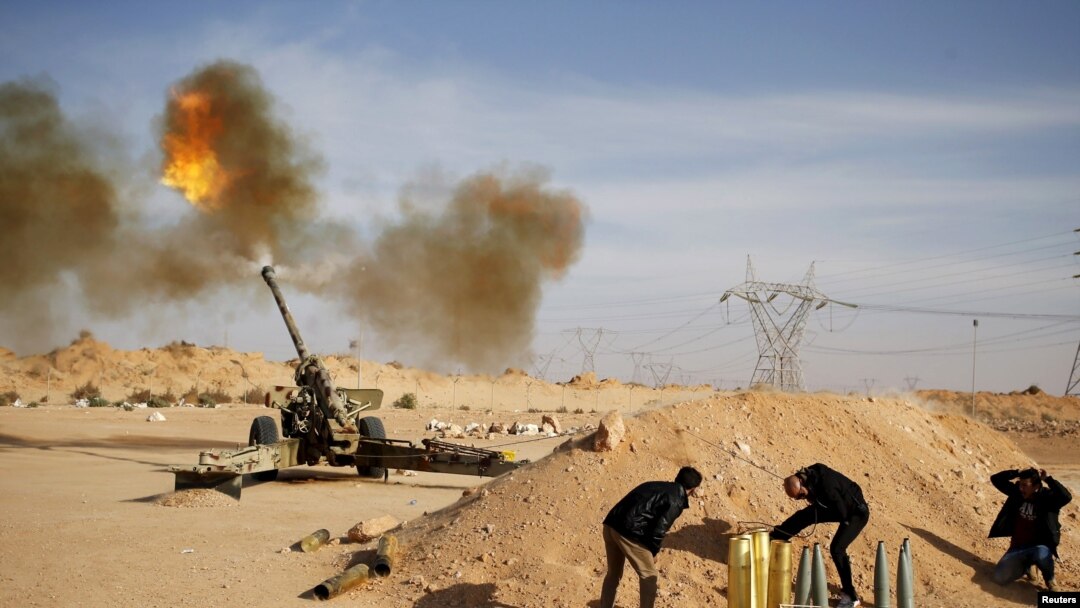 FILE - Libya Dawn fighters fire an artillery cannon at Islamic State militants near Sirte, March 19, 2015.