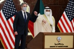 U.S. Secretary of State Antony Blinken and Kuwaiti Foreign Minister Sheikh Ahmed Nasser Al Mohammed Al Sabah bump elbows at their joint news conference at the Ministry of Foreign Affairs in Kuwait City, Kuwait, July 29, 2021.
