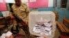 An Egyptian army soldier stands guard as officials count ballots after polls closed during the final stage of a referendum on Egypt's new constitution at the constitutional referendum commission in Cairo, Egypt, Jan. 15, 2014.