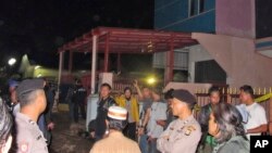 Officers stand guard around a house after it was raided by police in Bekasi, West Java, Indonesia, Dec. 10, 2016. 