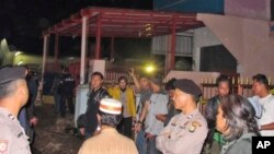 Officers stand guard around a house after it was raided by police in Bekasi, West Java, Indonesia, Dec. 10, 2016. Indonesian police said they safely detonated a bomb discovered in the raid and arrested suspected Islamic militants alleged to have been planning to attack the presidential palace.