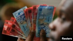 FILE - Ghana labor unions want the government to act to halt depreciation of Ghana's currency, the cedi.