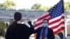 FILE - A federal immigration agency employee swears in an immigrant in a socially distanced outdoor naturalization ceremony, as the coronavirus disease outbreak continues, in Los Angeles, Feb. 5, 2021. 