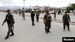 Afghan soldiers stand guard at the site of a blast in Kabul, Afghanistan, May 30, 2019.