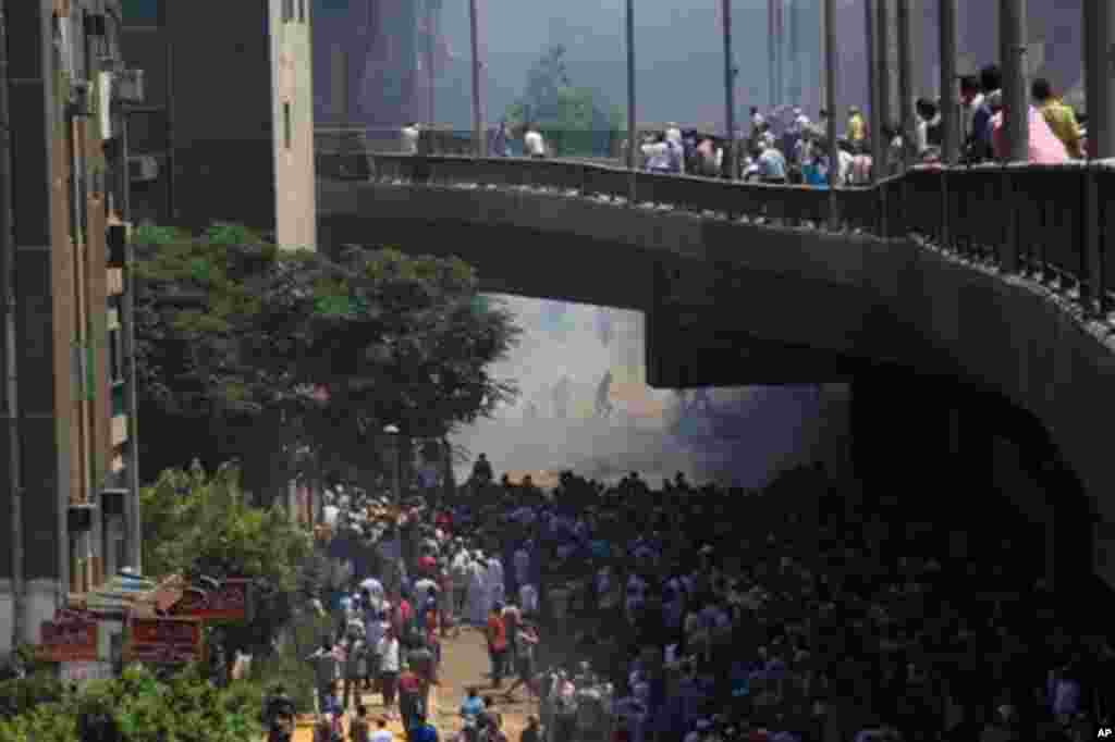 Supporters of Egypt's ousted President Mohammed Morsi clash with security forces near the largest sit-in.