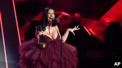 FILE - Singer Cardi B accepts the Best New Artist award during the 2018 iHeartRadio Music Awards at The Forum in Inglewood, California, March 11, 2018.