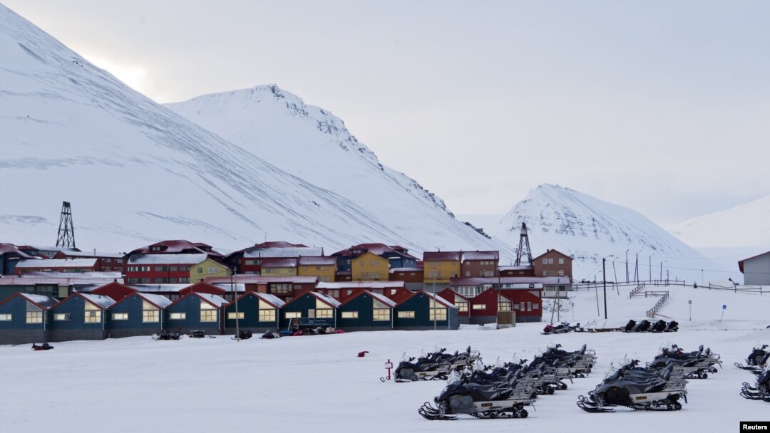 Snow scooters are seen parked in the town of Longyearbyen in Svalbard, March 26, 2012. 