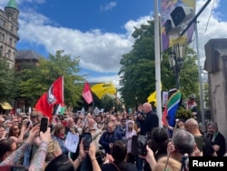 Anti-racism demonstrators hold flags to counter an anti-immigration protest in Belfast, Northern Ireland, on Aug. 3, 2024.