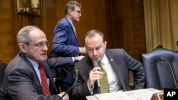 Sen. Jim Risch, R-Idaho (L) and Sen. Mike Lee, R-Utah, confer on Capitol Hill in Washington, Jan. 8, 2015, as the Senate Energy and Natural Resources Committee gathered for a markup on the long-stalled Keystone XL pipeline bill.