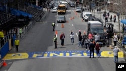 The newly applied Boston Marathon finish line rests on Boylston St., April 13, 2017, in Boston. The finish line is made from an adhesive decal that covers a painted version that is left in place throughout the year. The 121st Boston Marathon is to be run 