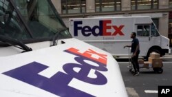 FILE - FedEx trucks are seen parked in New York, Aug. 22, 2017. Companies with ties to the National Rifle Association have been dealing with increasing public pressure since the Parkland, Florida, shooting that killed 17 people earlier this month to sever ties with the organization.