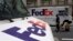 FILE - FedEx trucks are seen parked in New York, Aug. 22, 2017. Companies with ties to the National Rifle Association have been dealing with increasing public pressure since the Parkland, Florida, shooting that killed 17 people earlier this month to sever ties with the organization.