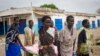 Women carry the body of a civilian killed in the center of Malakal, Upper Nile State in South Sudan, Jan. 21, 2014. The town erupted in violence again Tuesday.