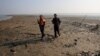 Bangladesh coast guards walk in the Thengar Char island in the Bay of Bengal, Bangladesh, Feb. 2, 2017.